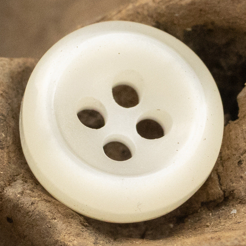White pearlized resin button with 4 holes, beveled edge