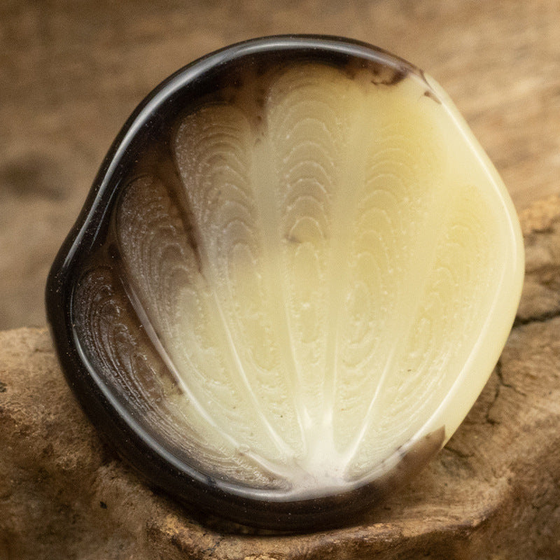 Yellow fan-shaped resin shank button with feather-textured surface
