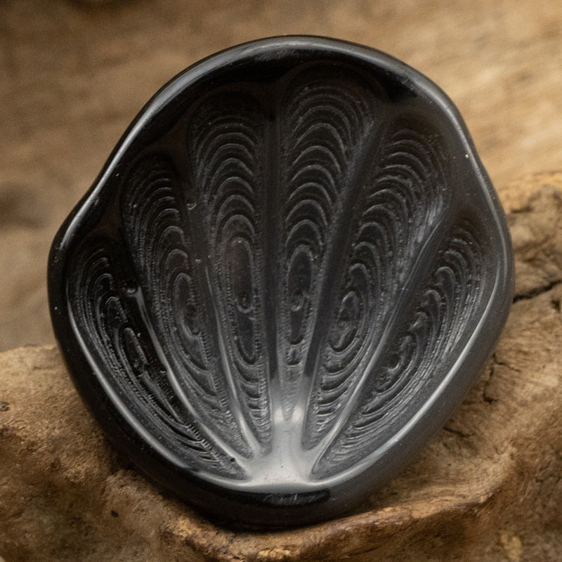 Black fan-shaped resin shank button with feather-textured surface