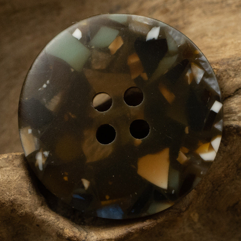 Dark resin button with floral glass texture and four holes