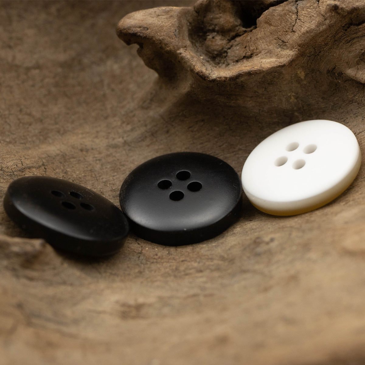 Set of resin buttons in black, dark and white, each with 4 holes and flat back