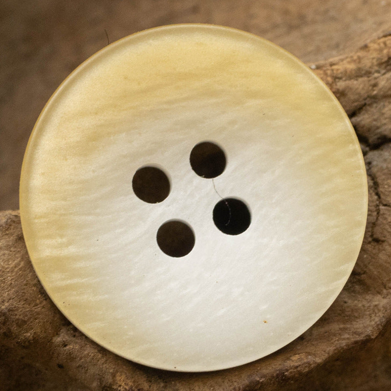 Light yellow resin button, flat with 4 holes