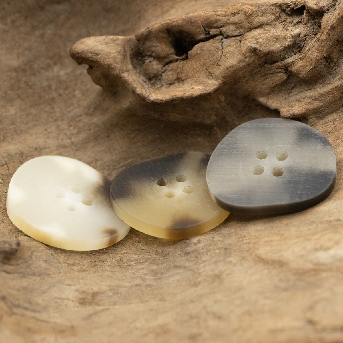 Peach-shaped resin buttons, mixed white, gray, and khaki, each with 4 holes