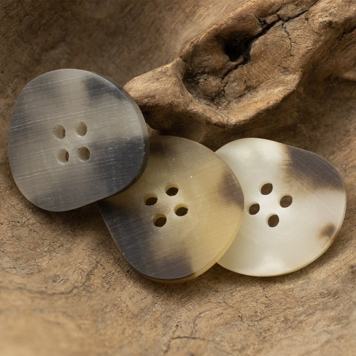 Peach-shaped resin buttons in gray, white, and khaki tones, 4-hole design