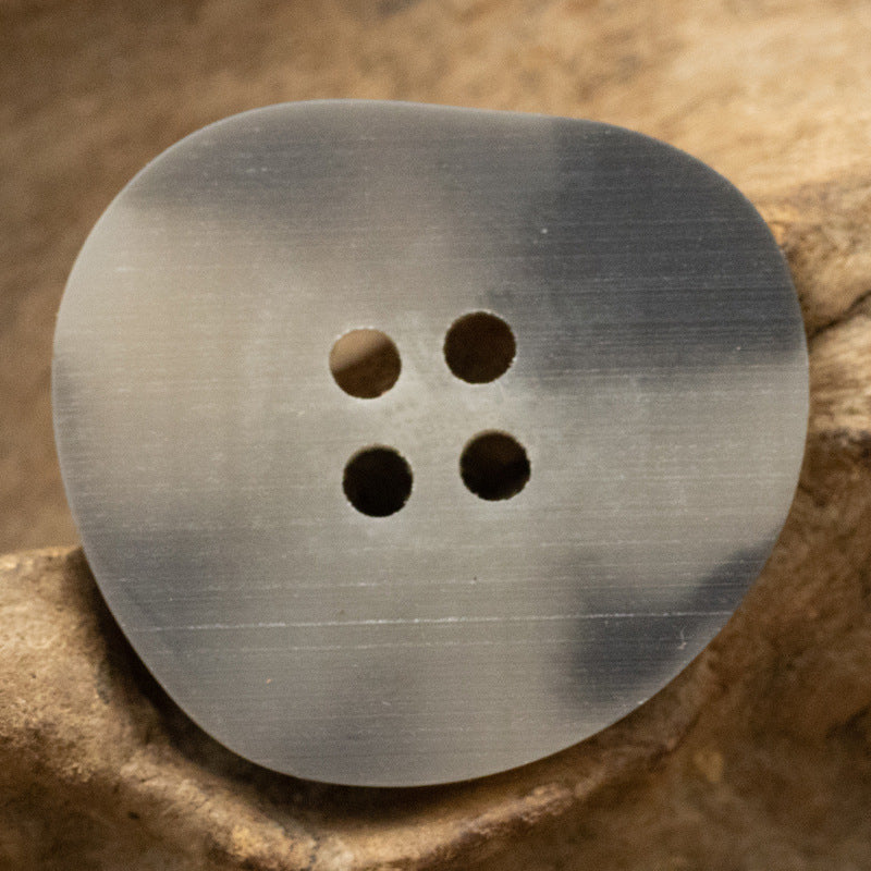 Peach-shaped resin buttons in gray tone, round 4-hole front