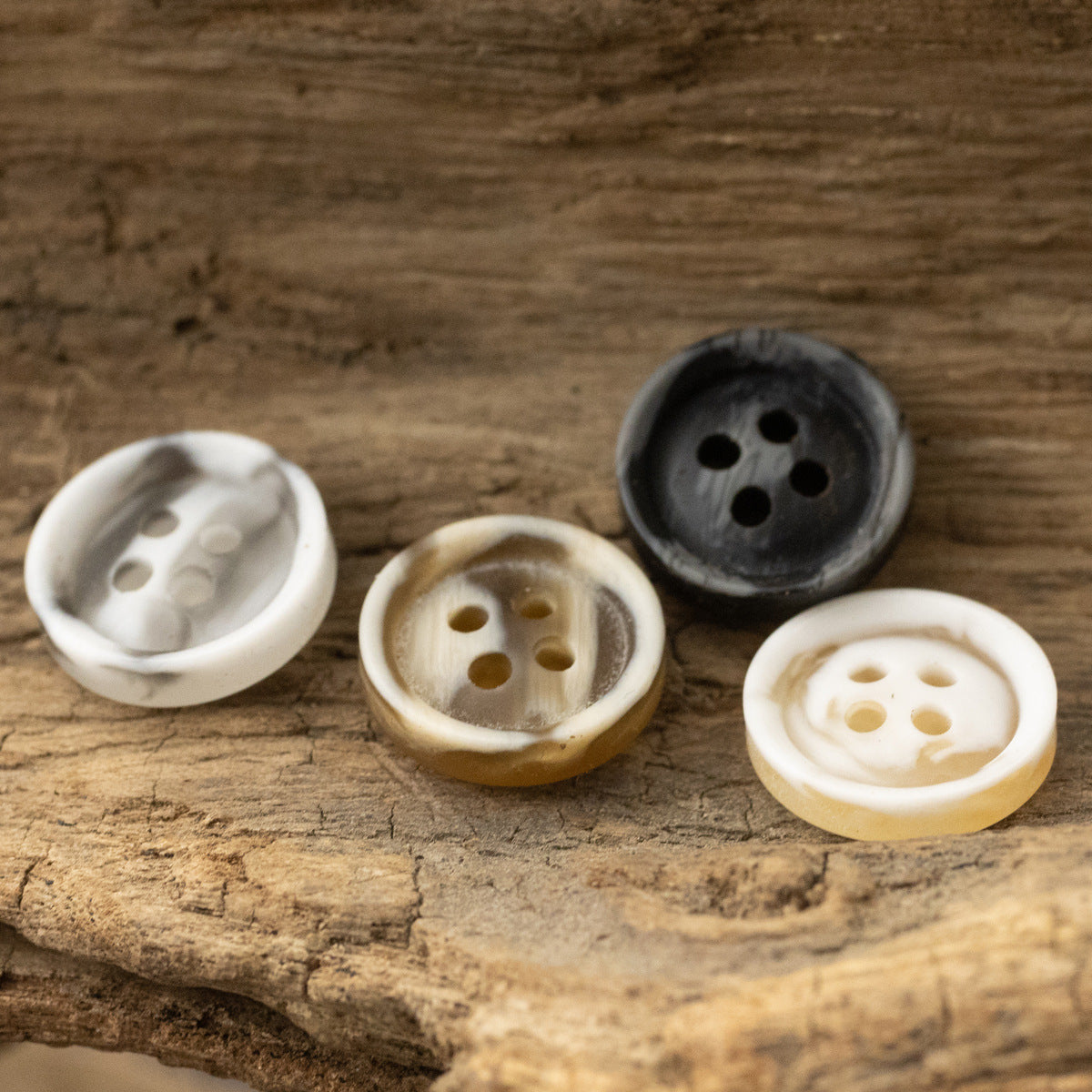 Resin buttons 10/11.5 mm, 4-hole, visible button backs in white, tan, and dark gray.