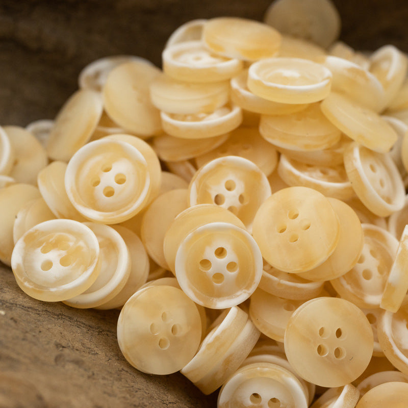 Resin buttons 10/11.5 mm, 4-hole, cream and light yellow buttons pile.