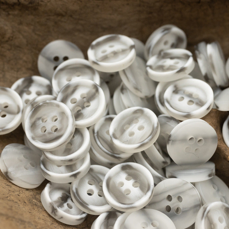 Resin buttons 10/11.5 mm, 4-hole, white buttons with subtle marbling pile.