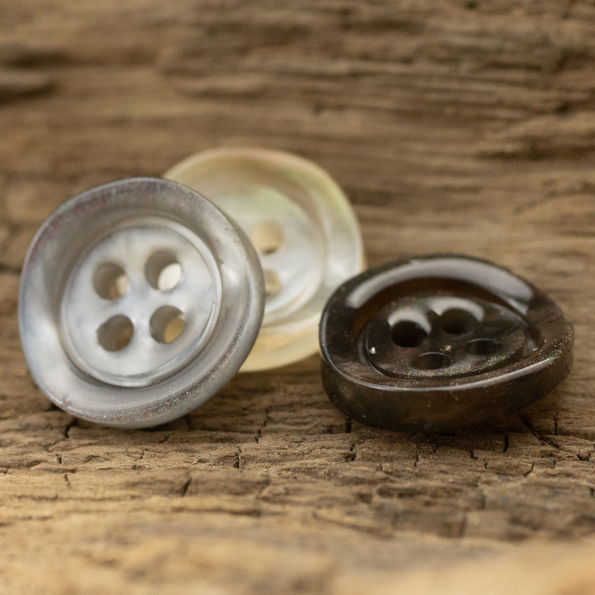 Pair translucent glazed pearl resin buttons: gray and dark brown, four holes, wide edge