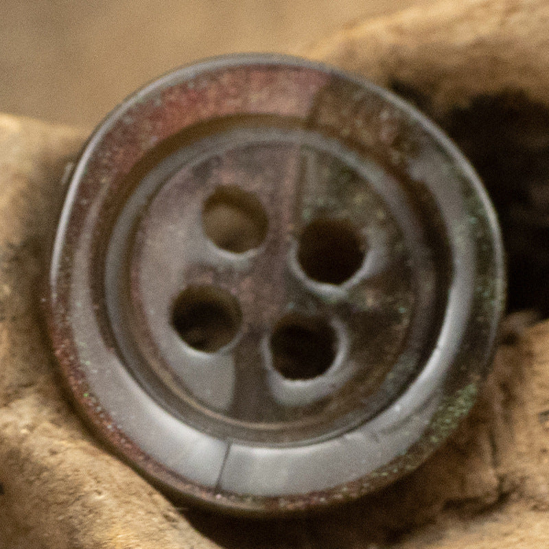 Dark brown translucent glazed pearl resin button with four holes and glossy wide edge