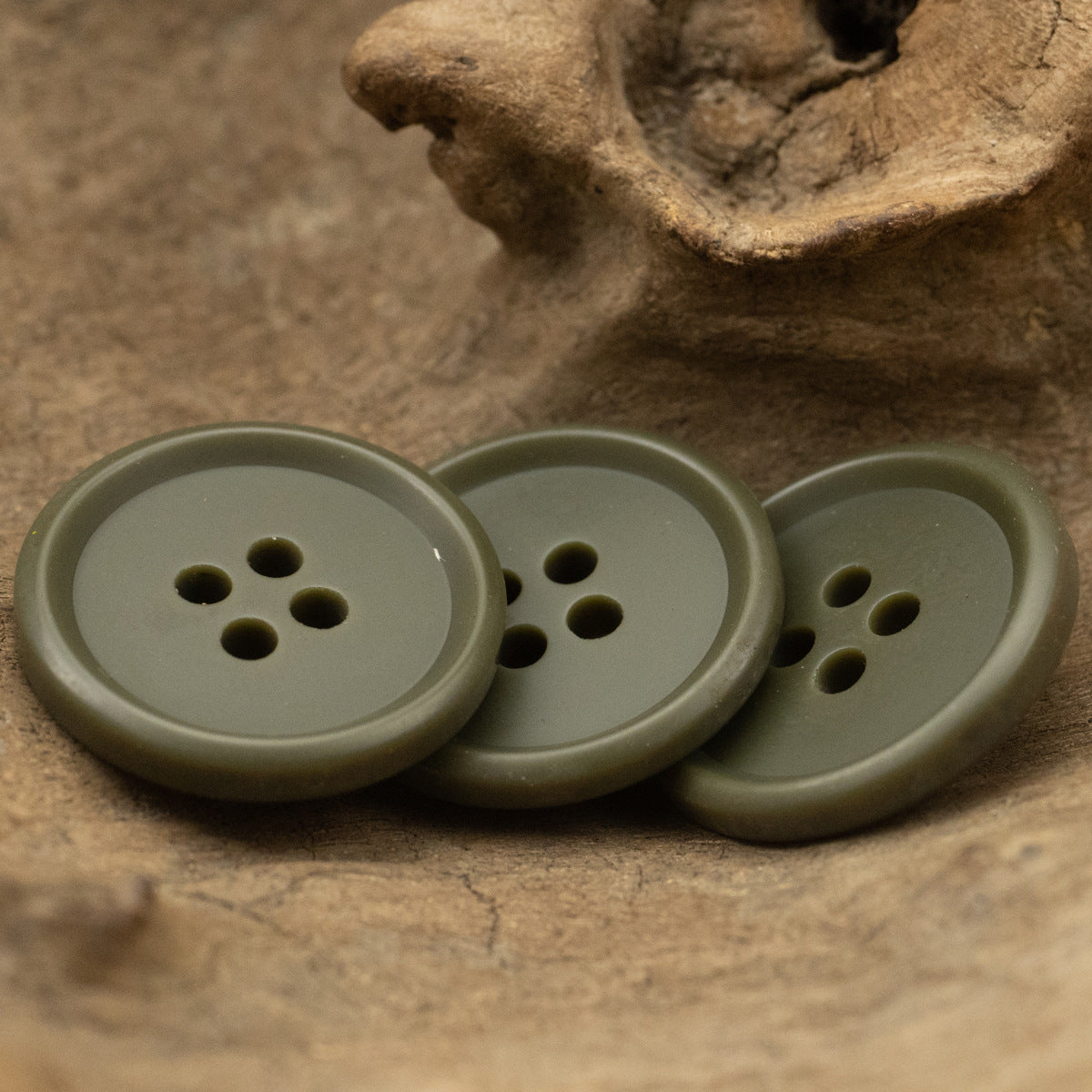 Matte army green round resin buttons with 4 holes, side-by-side