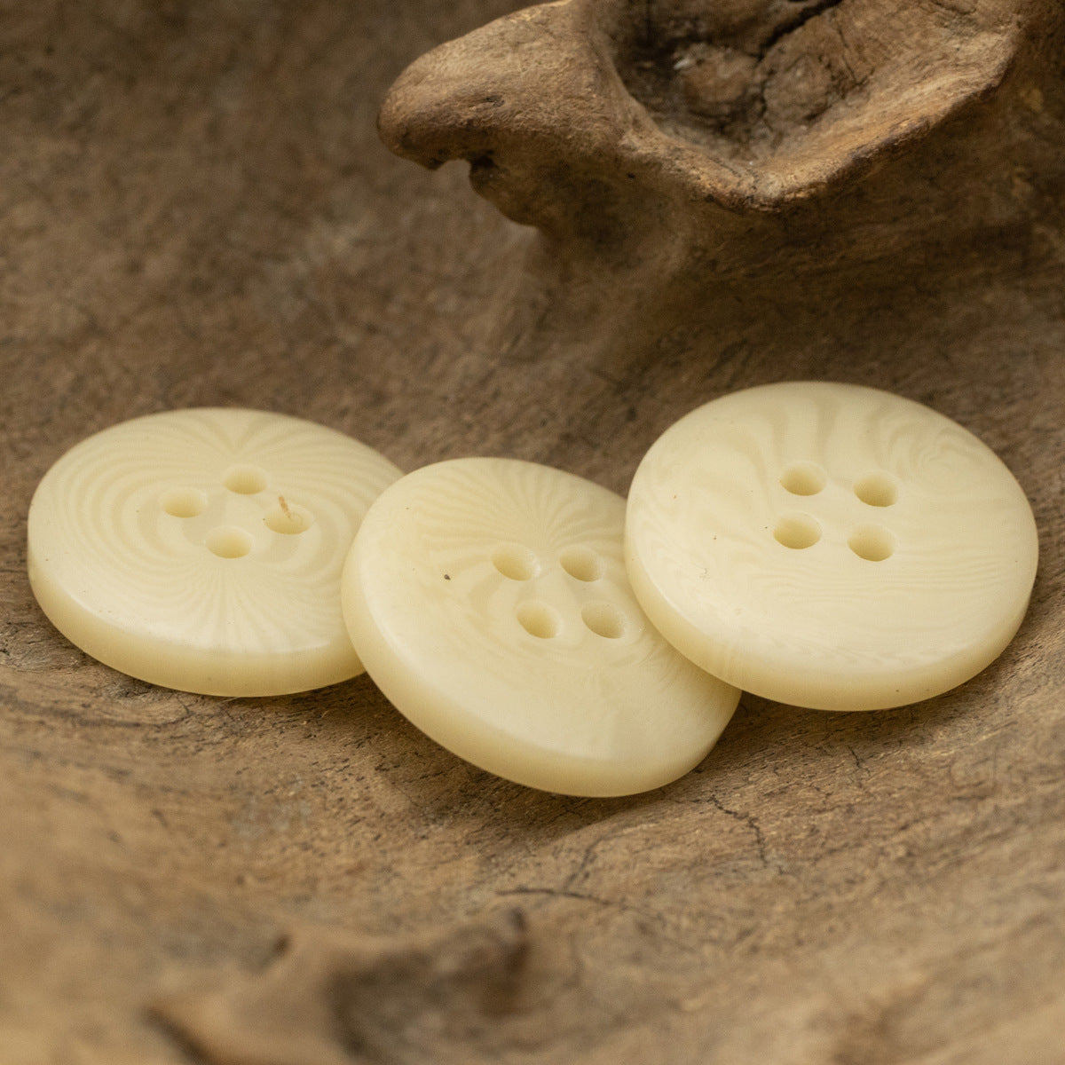 Yellow resin buttons with fruit-texture raised pattern, 4-hole backs