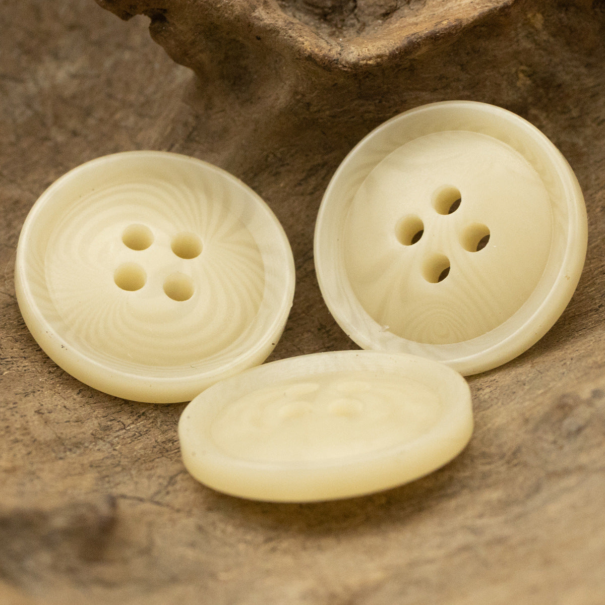 Yellow resin button pair showing 4-hole fronts and backs with fruit texture