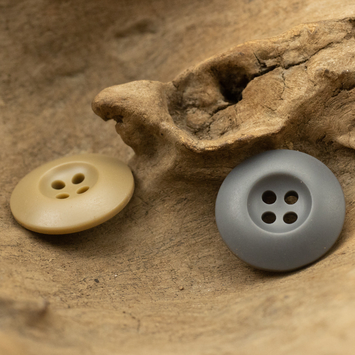 Khaki and gray 4-hole resin buttons for jackets or casual pants, shown together.