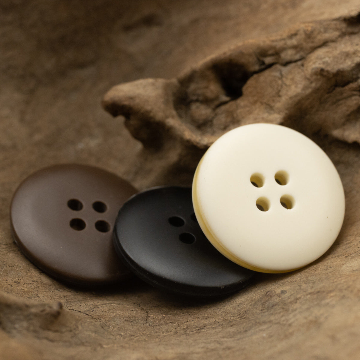 Round resin coat buttons with four holes: white, coffee, and dark buttons.