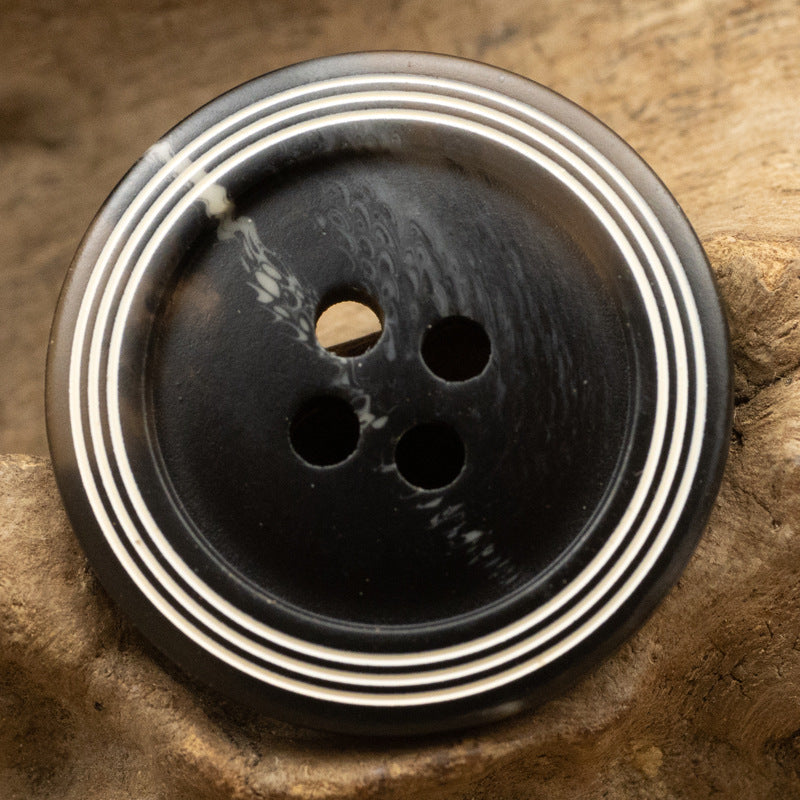 Black matte 4-hole resin button with white ring stripes