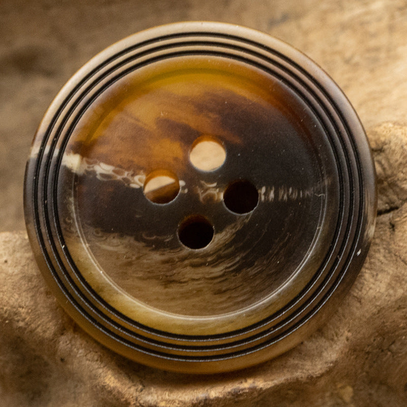 Dark amber matte 4-hole resin button with black ring stripes