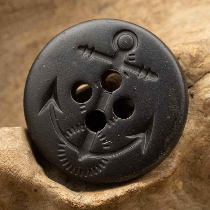 Matte black anchor resin button, round 4-hole close-up