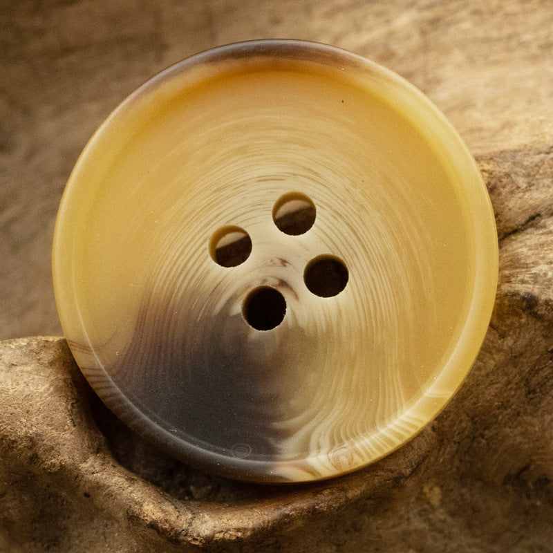 Round matte resin 4-hole button, yellow/golden tone closeup
