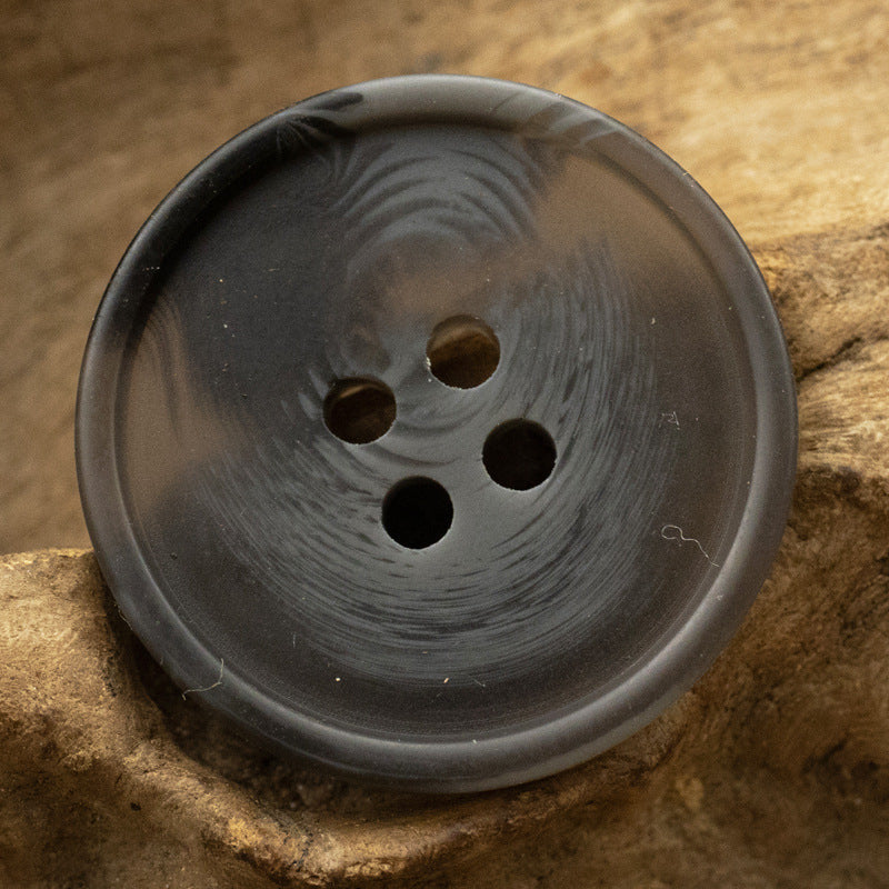 Round matte resin 4-hole button, dark gray color closeup