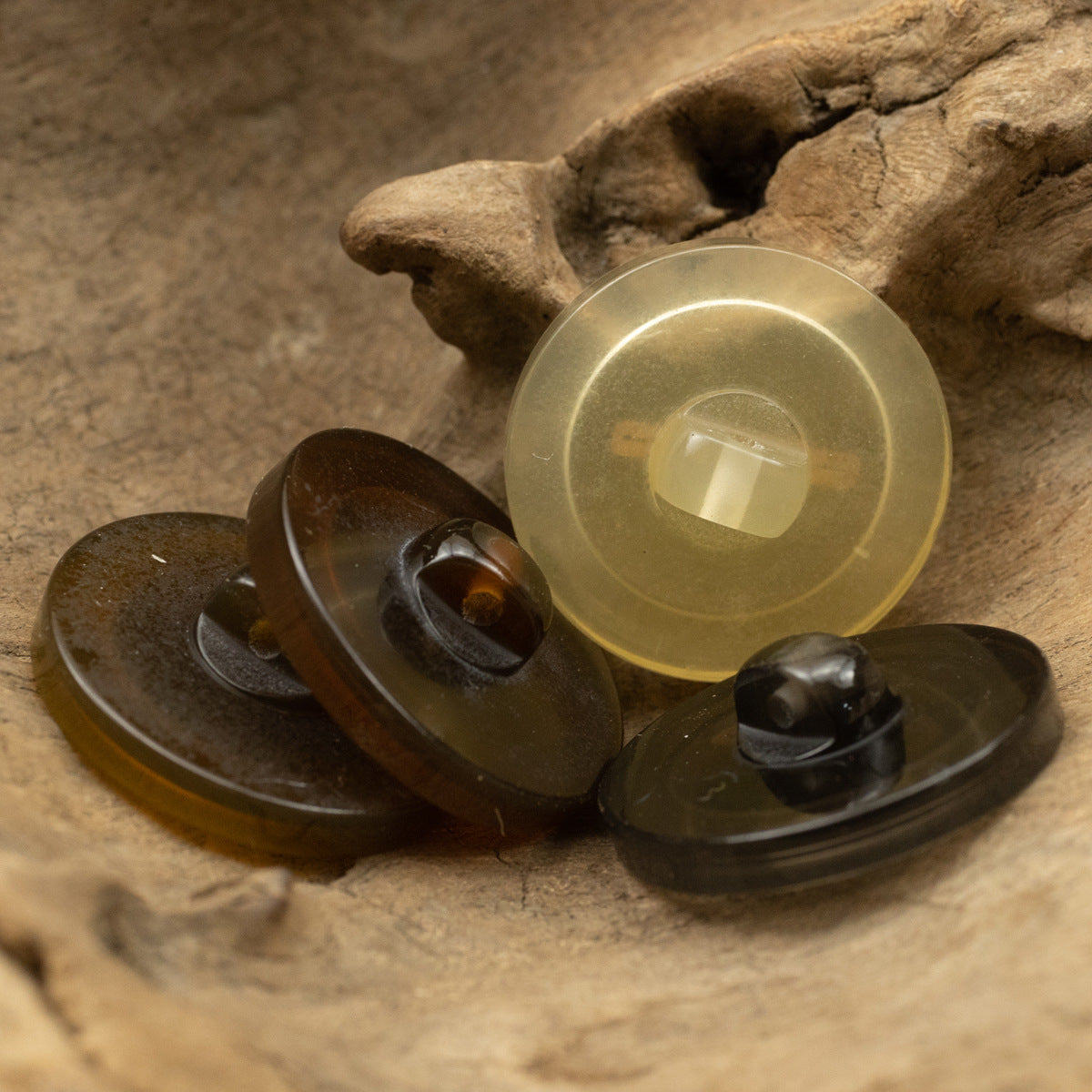 Set of translucent resin buttons in light yellow with gold-foil bar details