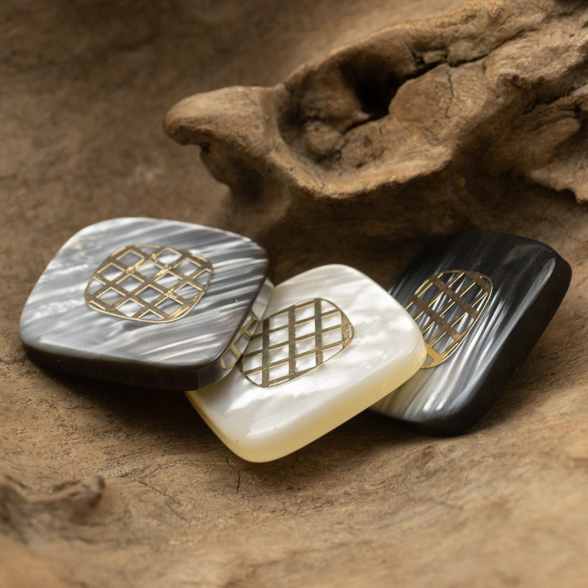 Set of three square resin buttons with gold-foil grid in light-to-dark tones