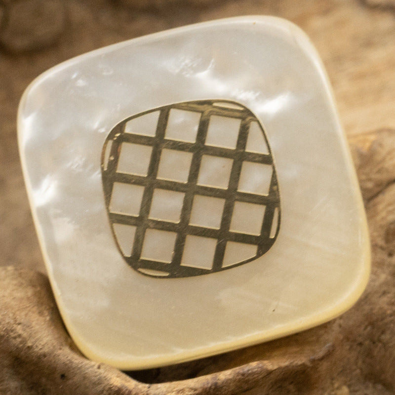 Square resin button, champagne tone with gold-foil check grid