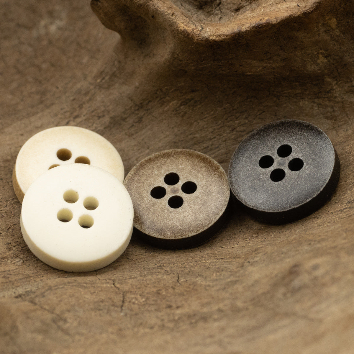 Distressed resin buttons, 4-hole style: cream, taupe, dark gray (3 buttons).