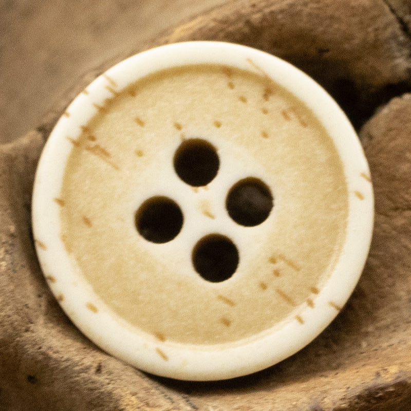 Ivory distressed resin button with bone-grain look, 4-hole front design.
