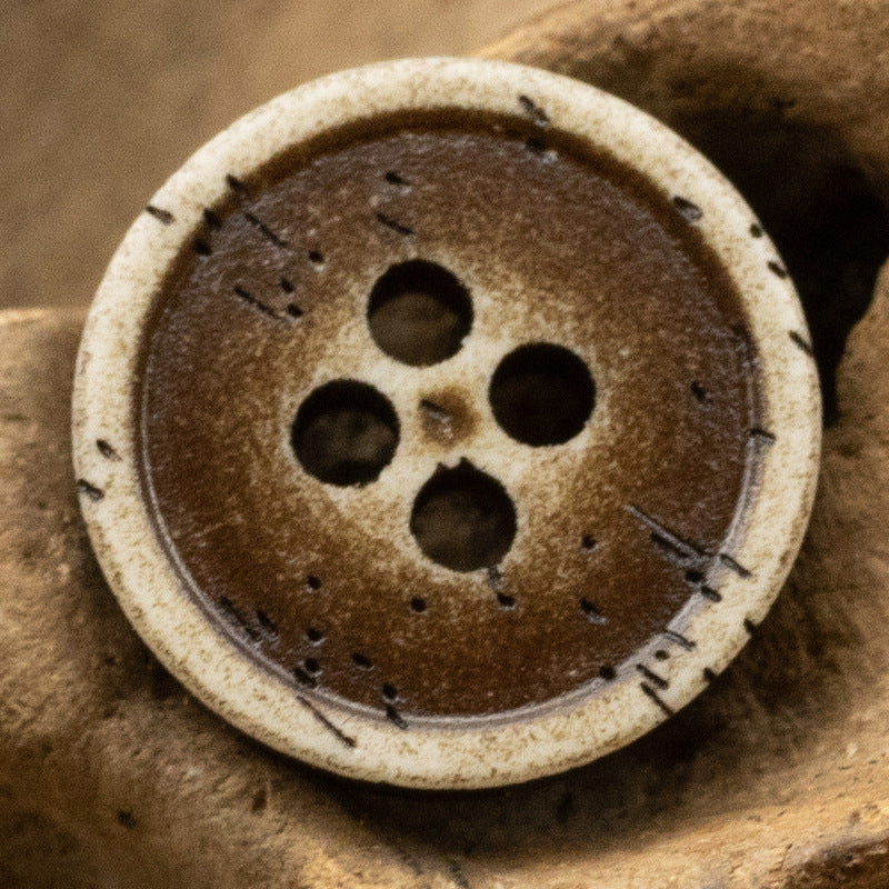 Brown distressed resin button with bone-grain look, 4-hole front design.