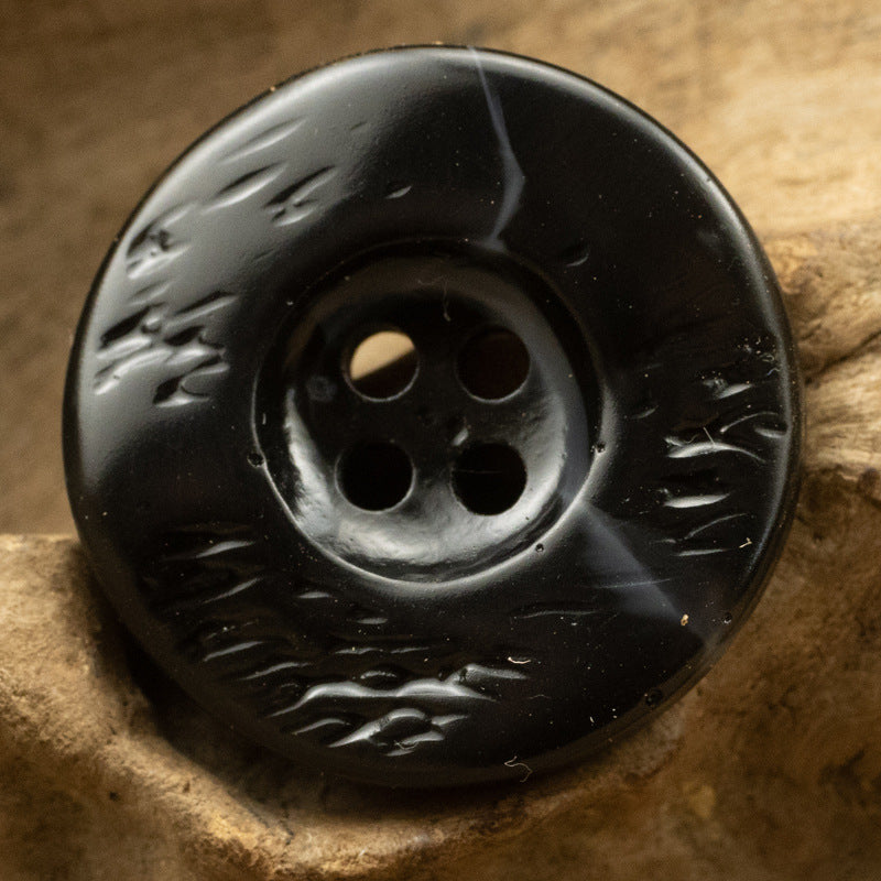 Black resin button, thickened irregular curved shape, 4-hole, raised leaf texture