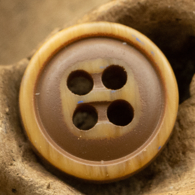 Brown four-hole resin button with dark holes, simple woodgrain rim.