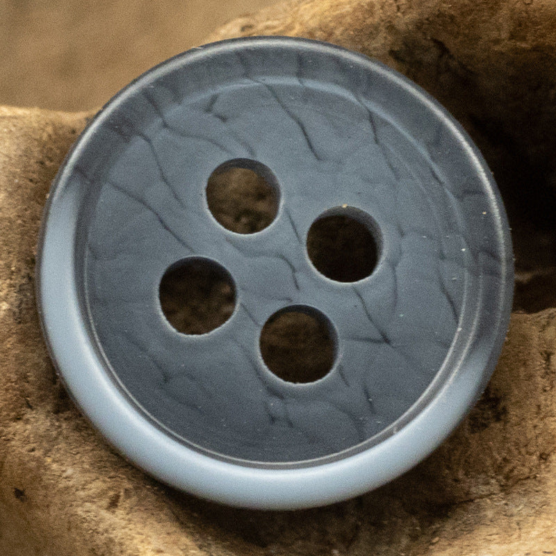 Dark blue resin button, four-hole design with textured finish