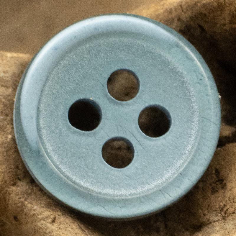 Lake blue resin button, four-hole design with subtle marbled texture