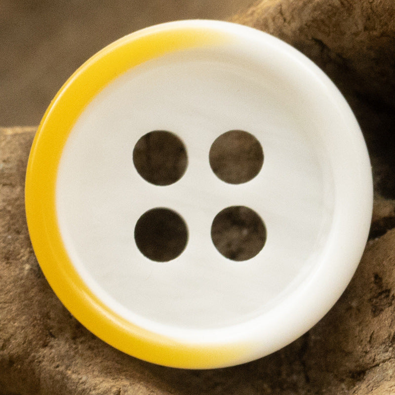 Yellow-rim white resin button, four-hole design