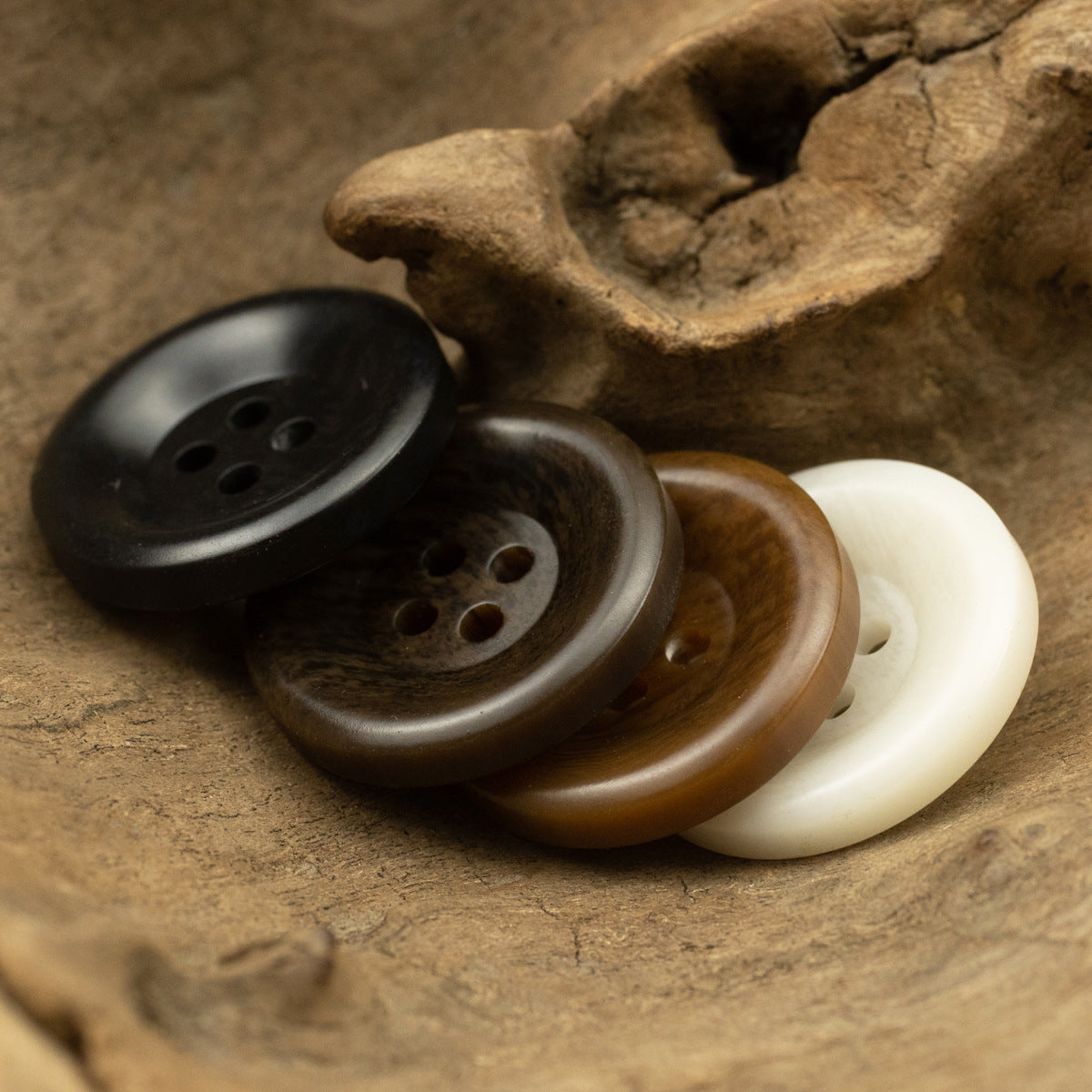 Resin buttons bundle: black, dark brown, tan and cream tones, four-hole fronts