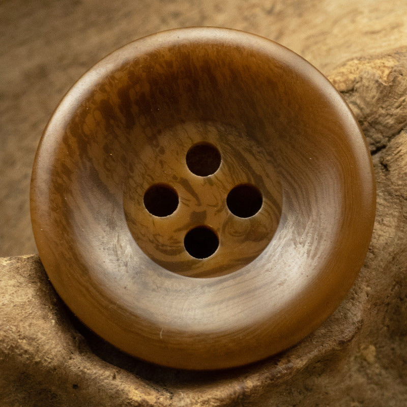 Wide-edged resin button, honey brown with lighter rim, four holes