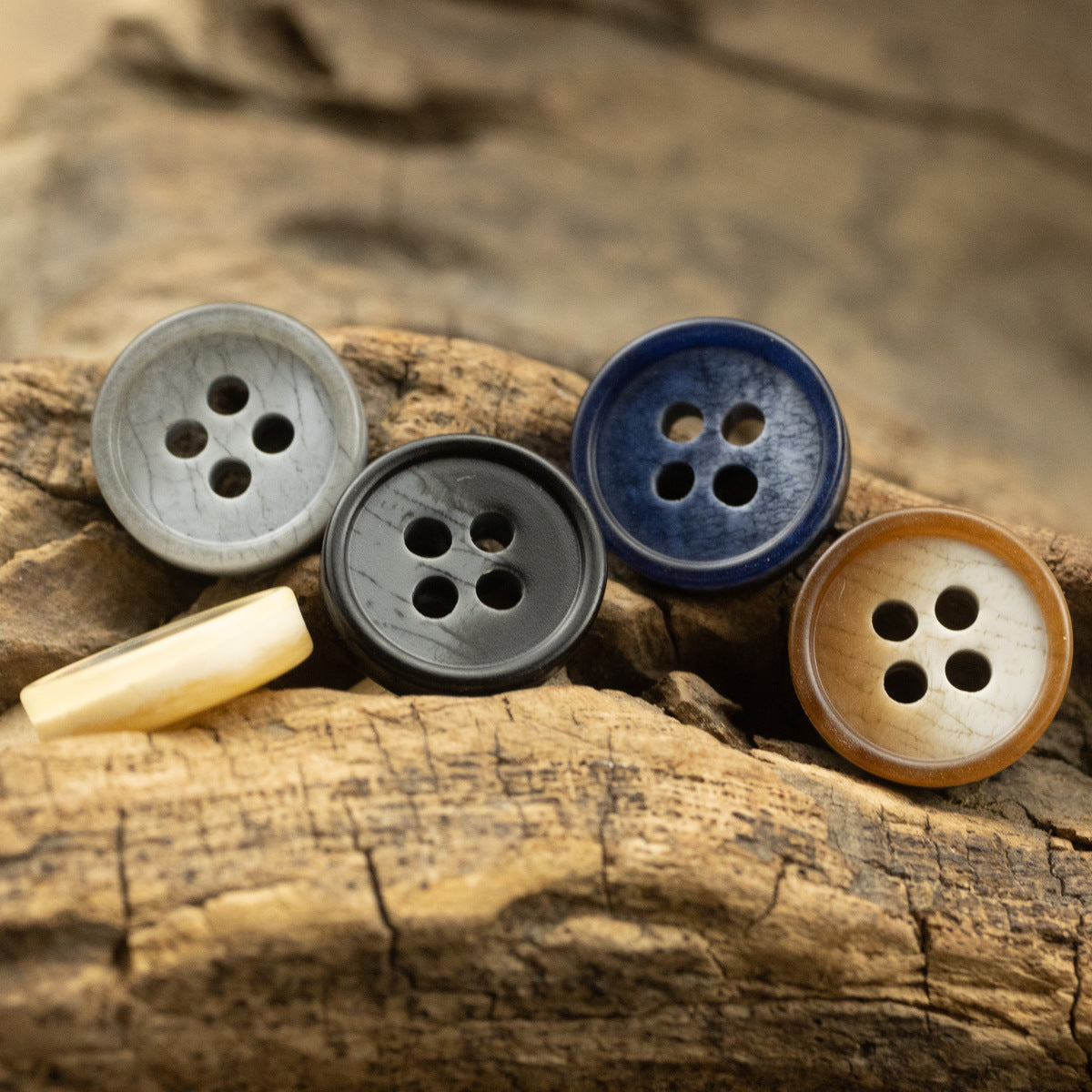 Mixed resin 4-hole buttons on wood: gray, black, deep blue, khaki, brownish