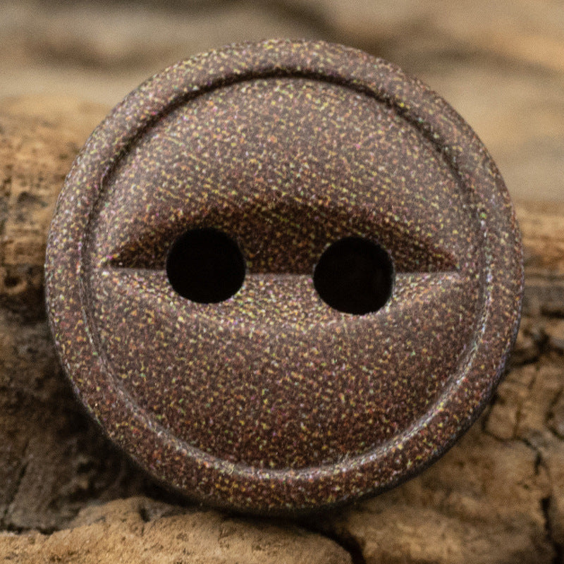 Coffee-brown speckled resin button, close-up of two-hole round face