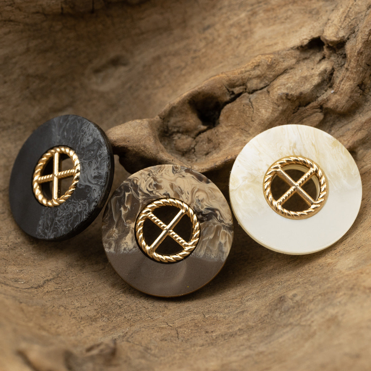 Set of round resin buttons in black, coffee, and white with gold cross in wreath