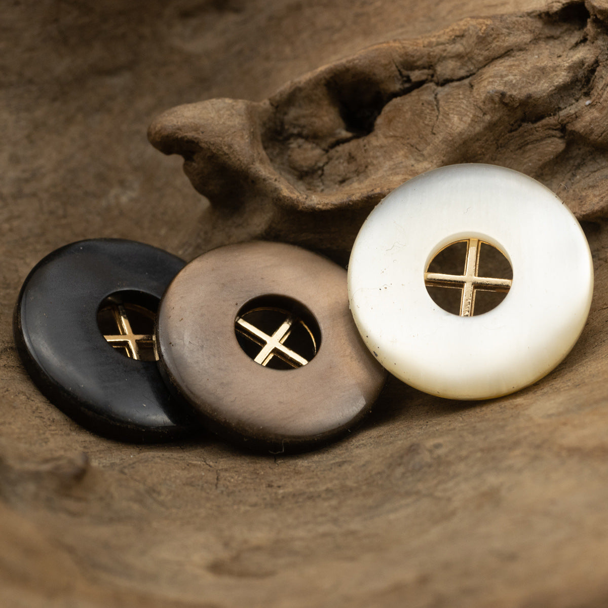 Round resin buttons on display: black, coffee, and white with gold cross accents