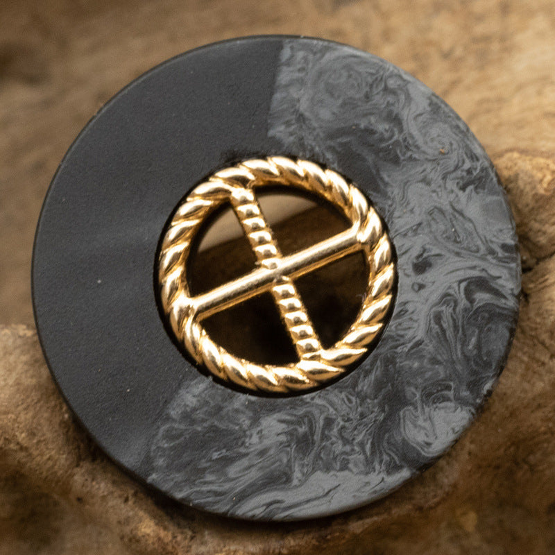 Round black resin button with gold cross design in rope wreath metal border