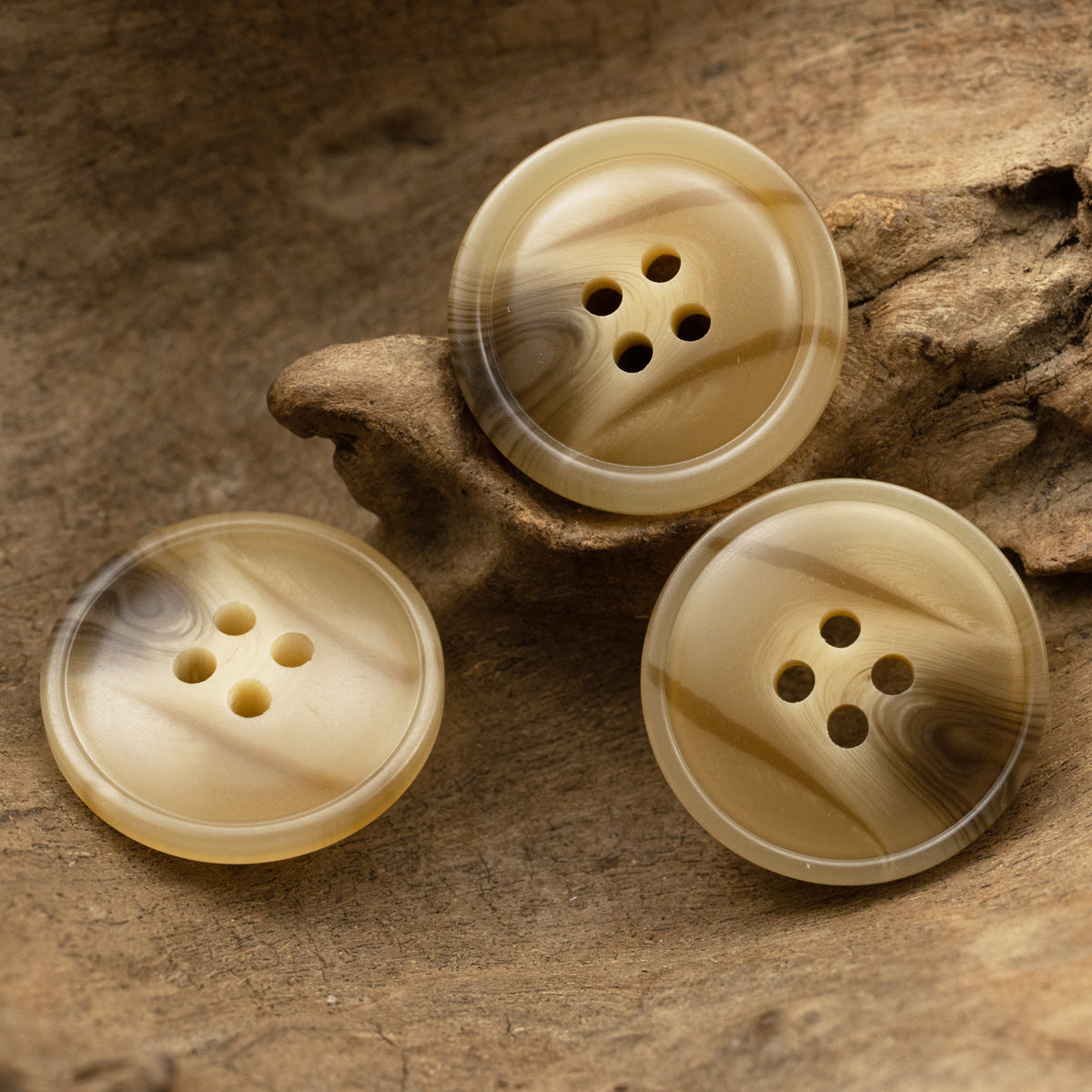 Three khaki resin coat buttons, round 4-hole, subtle swirled woodgrain finish