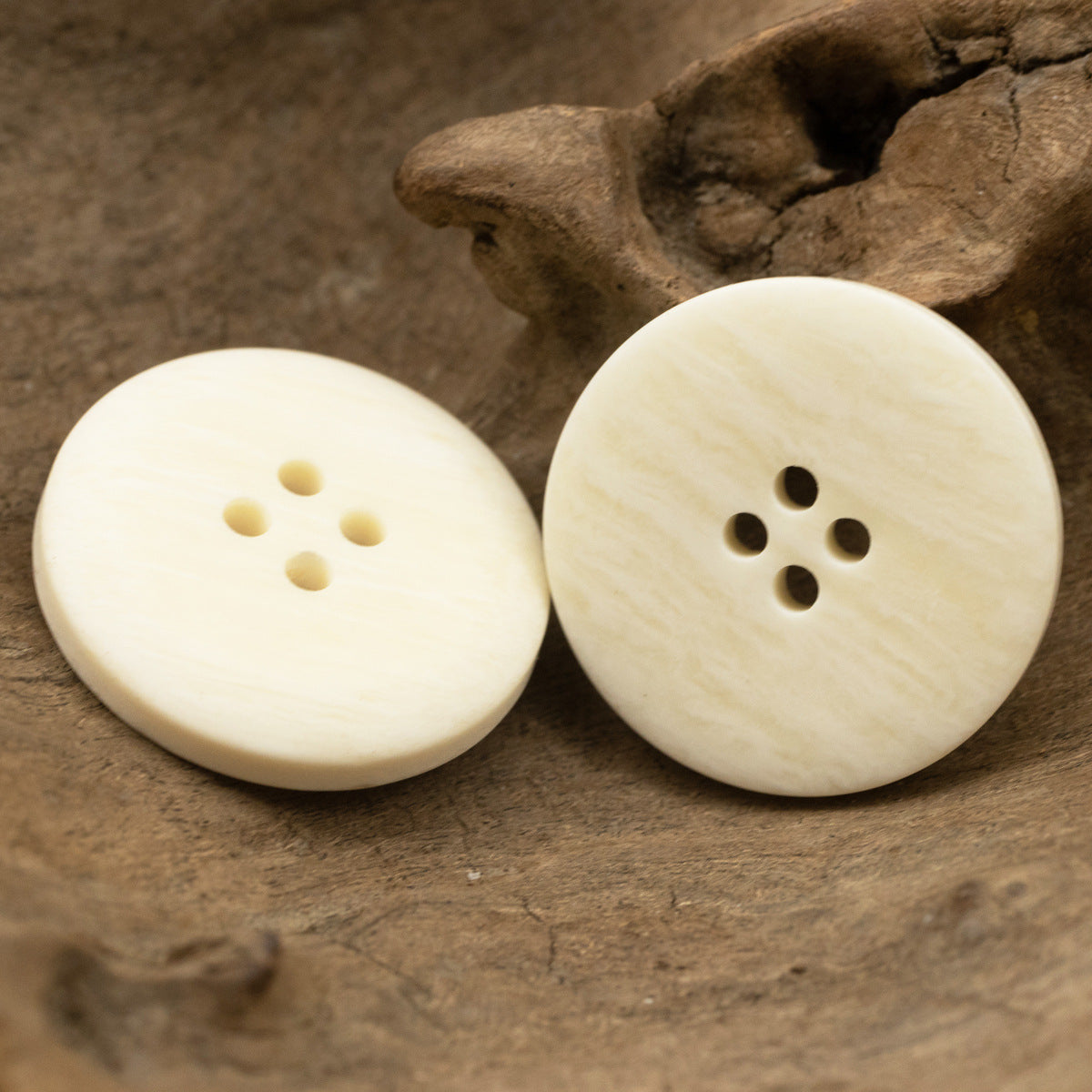 White resin 4-hole buttons, smooth round face with ox-bone grain look