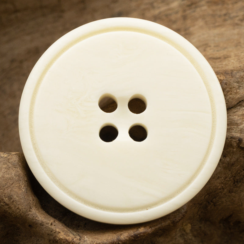 White resin suit jacket button, 4-hole, broad edge, ox-bone grain effect