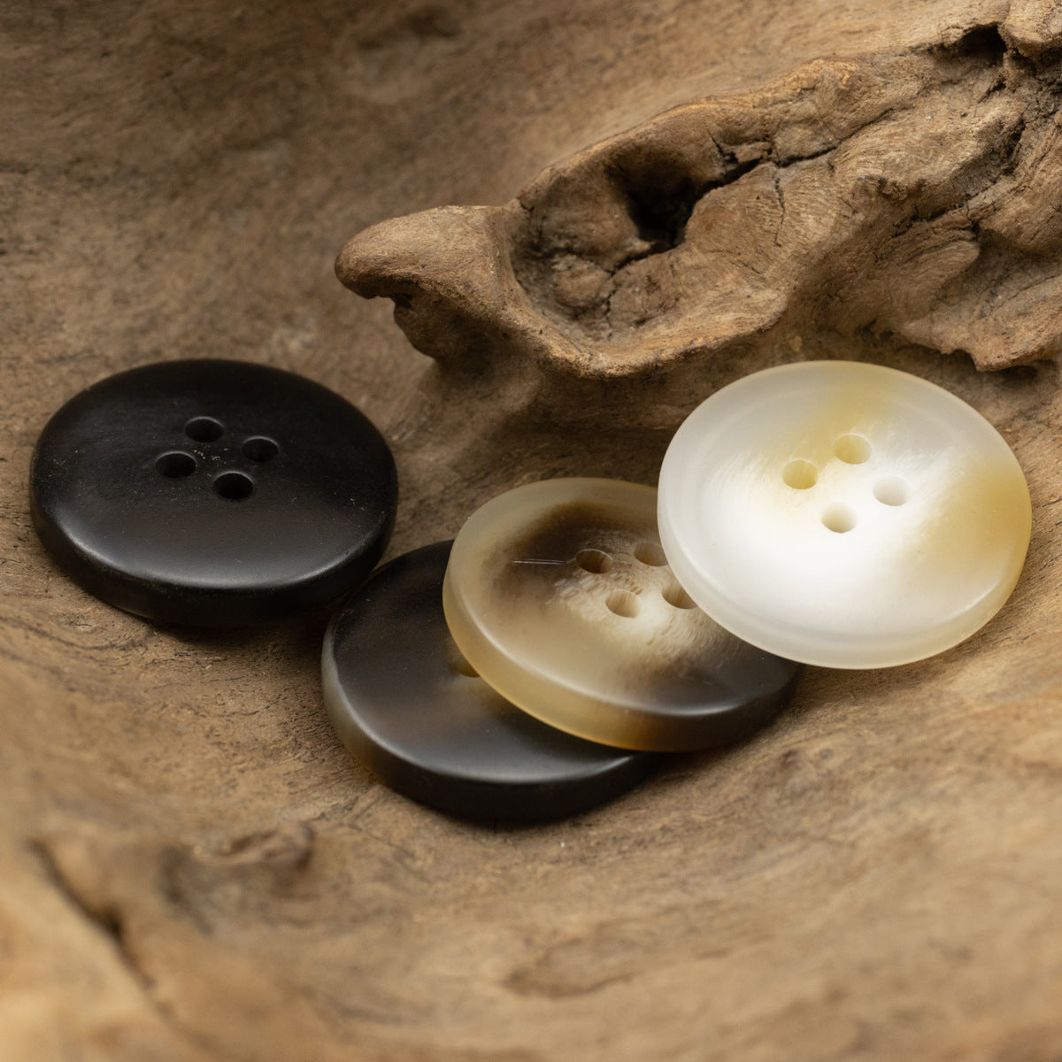 Four-hole resin buttons in dark and light brown, plus beige/cream tones (set shown)