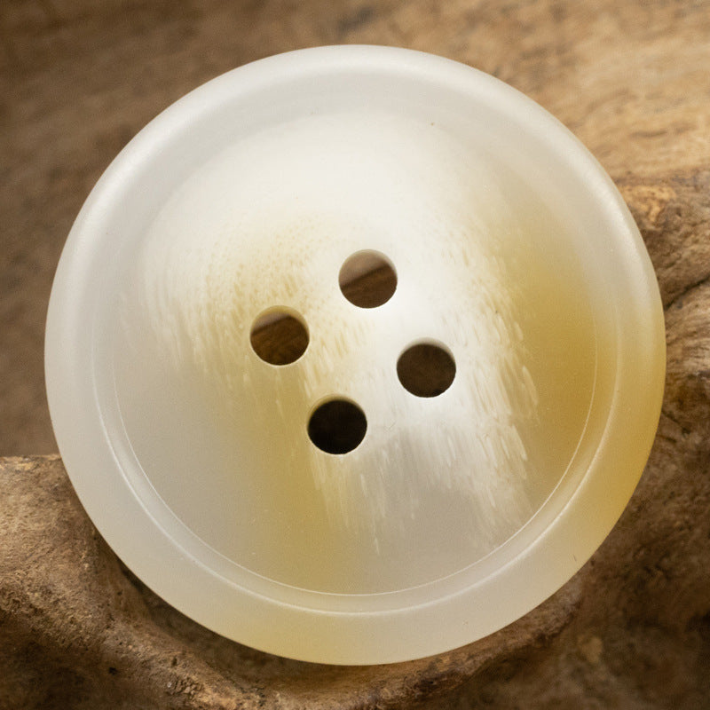 Ivory/cream resin button with four holes, smooth round face