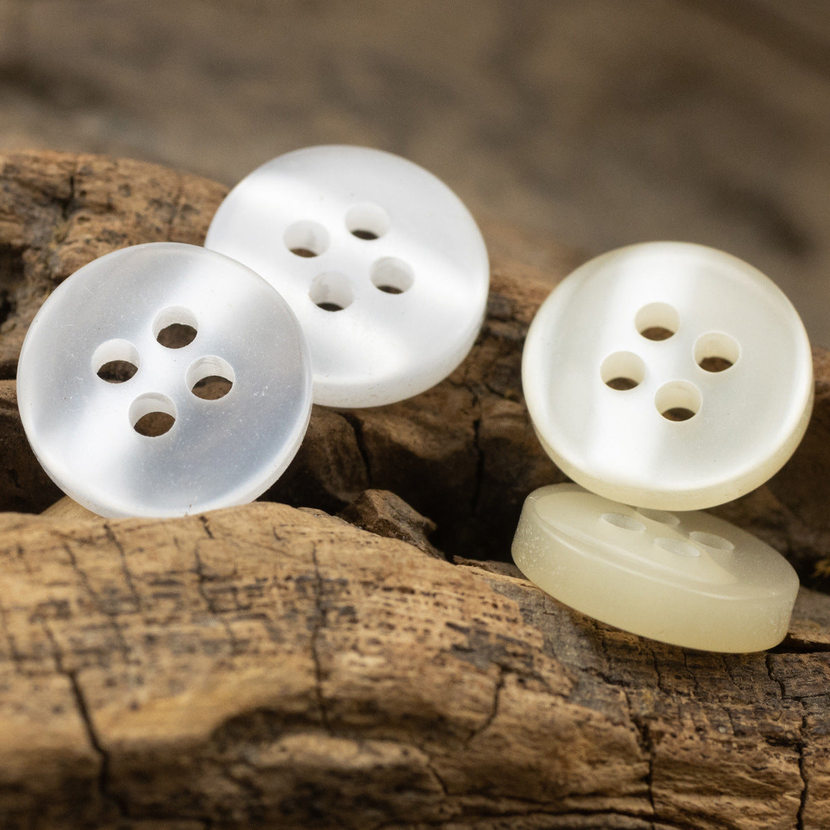 White and light yellow resin buttons, 4-hole design, several buttons