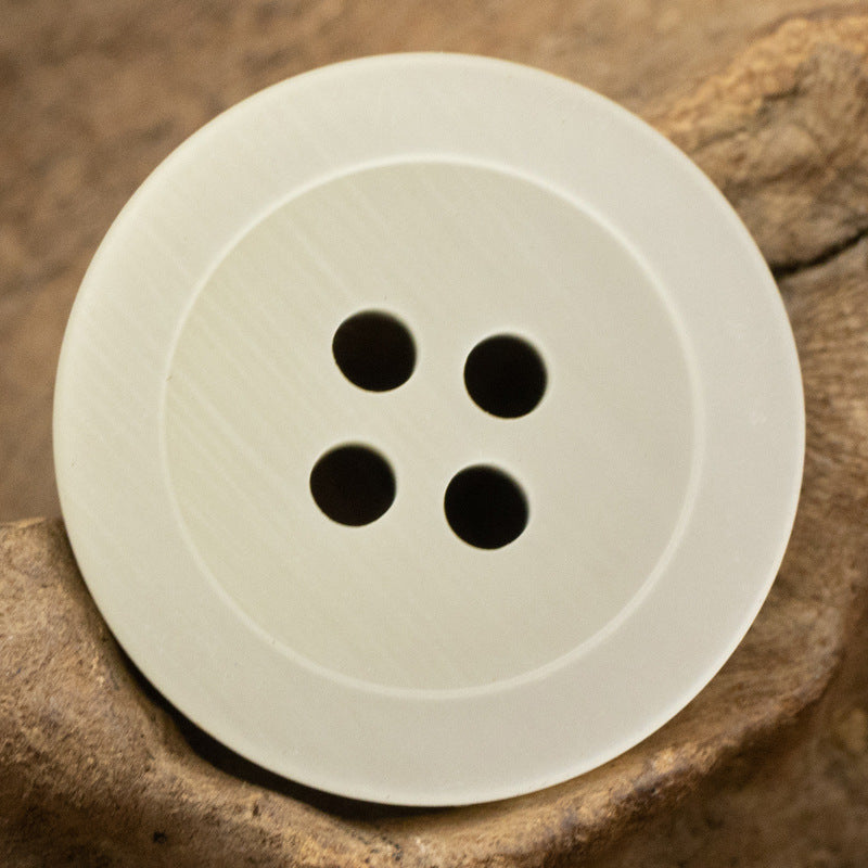 White round 4-hole resin button, smooth front with four holes