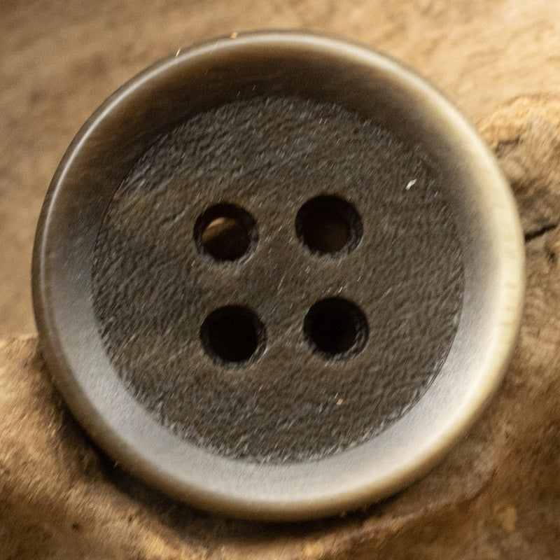 Dark 4-hole resin sewing button, gradient frosted surface, close-up